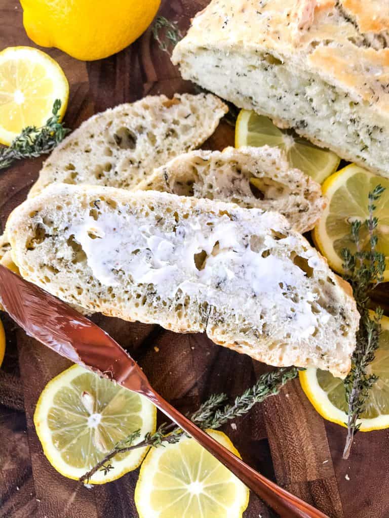 No Knead Rustic Lemon Thyme Bread is a simple homemade bread recipe. No knead and cooked in a Dutch oven, full of Italian flavors with lemon and dried herbs. #rusticbread #nokneadbread #Italianbread