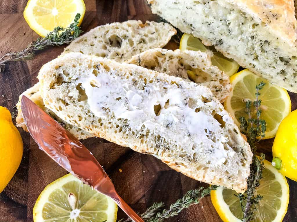 No Knead Rustic Lemon Thyme Bread is a simple homemade bread recipe. No knead and cooked in a Dutch oven, full of Italian flavors with lemon and dried herbs. #rusticbread #nokneadbread #Italianbread