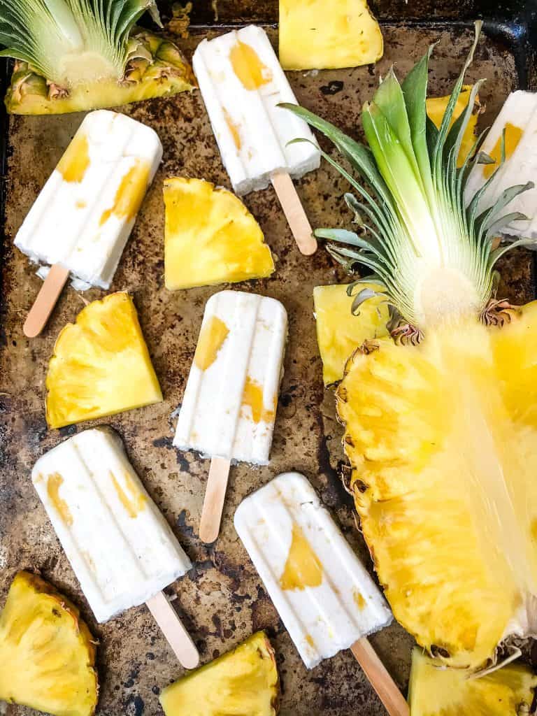 Pina Colada Popsicles are easy and healthy homemade popsicles made with coconut milk and pineapple. Add rum if desired for an alcohol popsicle poptail. Gluten free and vegan. #homemadepopsicles #pinacolada #coconutpopsicles