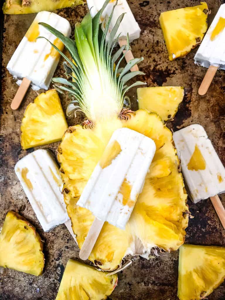 Pina Colada Popsicles are easy and healthy homemade popsicles made with coconut milk and pineapple. Add rum if desired for an alcohol popsicle poptail. Gluten free and vegan. #homemadepopsicles #pinacolada #coconutpopsicles