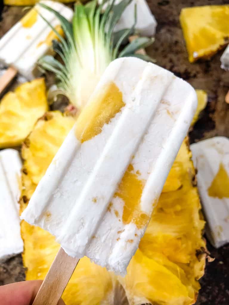 Pina Colada Popsicles are easy and healthy homemade popsicles made with coconut milk and pineapple. Add rum if desired for an alcohol popsicle poptail. Gluten free and vegan. #homemadepopsicles #pinacolada #coconutpopsicles