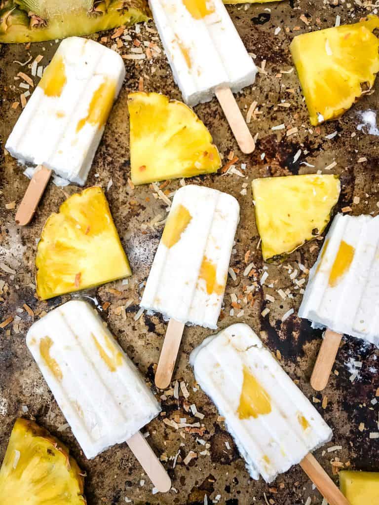 Pina Colada Popsicles are easy and healthy homemade popsicles made with coconut milk and pineapple. Add rum if desired for an alcohol popsicle poptail. Gluten free and vegan. #homemadepopsicles #pinacolada #coconutpopsicles