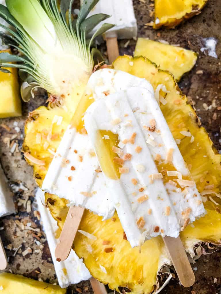 Pina Colada Popsicles are easy and healthy homemade popsicles made with coconut milk and pineapple. Add rum if desired for an alcohol popsicle poptail. Gluten free and vegan. #homemadepopsicles #pinacolada #coconutpopsicles