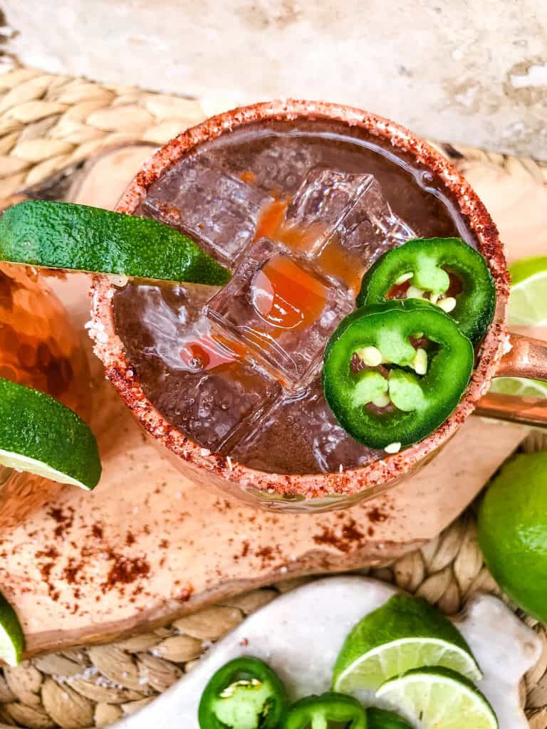 Spicy Mexican Mule Cocktail recipe is a twist on the classic drink using tequila instead of vodka with ginger beer, lime, and heat with a salt rim. A simple and delicious Moscow Mule variation. #mexicanmule #tequilacocktail #moscowmule #spicycocktail