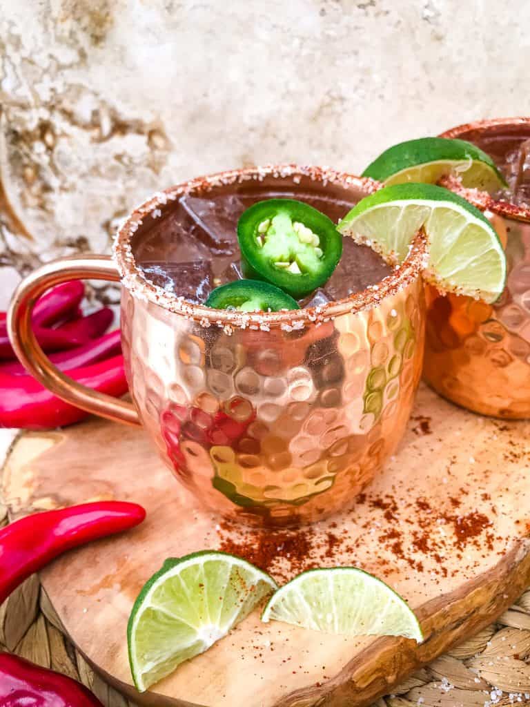 Spicy Mexican Mule Cocktail recipe is a twist on the classic drink using tequila instead of vodka with ginger beer, lime, and heat with a salt rim. A simple and delicious Moscow Mule variation. #mexicanmule #tequilacocktail #moscowmule #spicycocktail