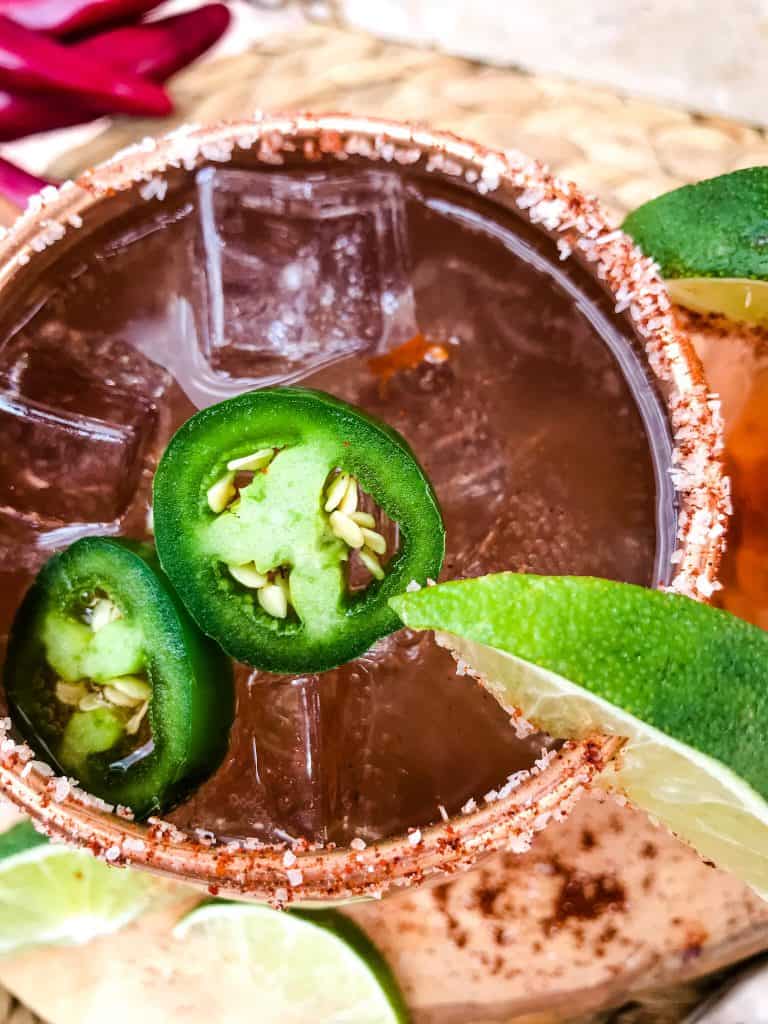 Spicy Mexican Mule Cocktail recipe is a twist on the classic drink using tequila instead of vodka with ginger beer, lime, and heat with a salt rim. A simple and delicious Moscow Mule variation. #mexicanmule #tequilacocktail #moscowmule #spicycocktail