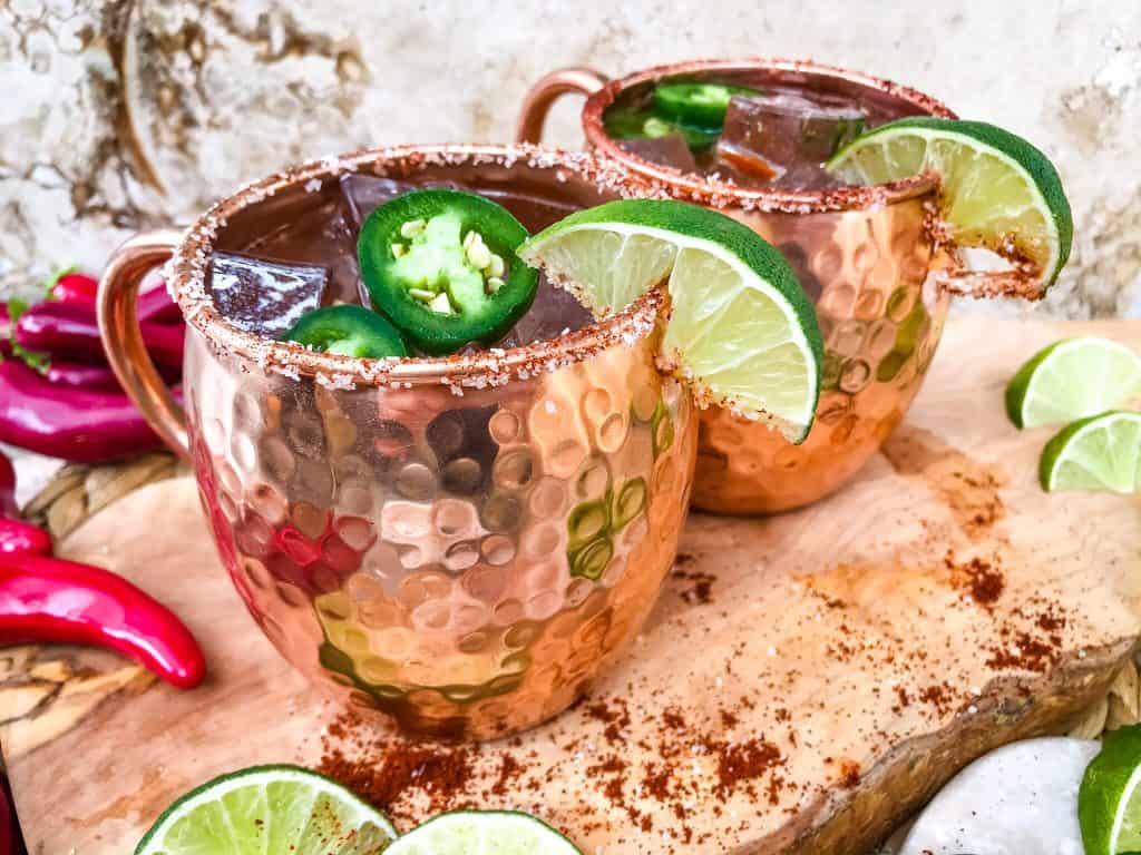 Spicy Mexican Mule Cocktail recipe is a twist on the classic drink using tequila instead of vodka with ginger beer, lime, and heat with a salt rim. A simple and delicious Moscow Mule variation. #mexicanmule #tequilacocktail #moscowmule #spicycocktail