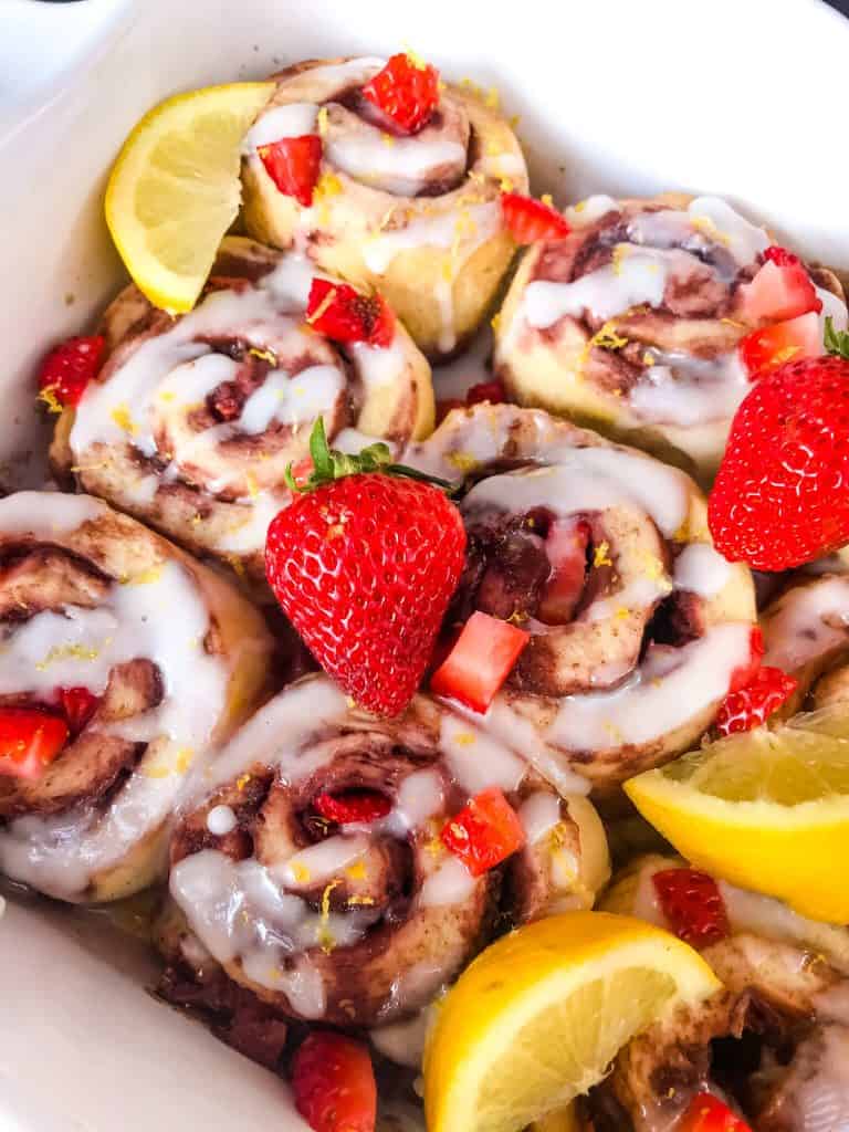 Homemade Strawberry Lemon Cinnamon Rolls with lemon icing glaze. Fresh strawberries and strawberry jam with cinnamon in a homemade dough. Bright spring and summer flavors for home breakfast and brunch baking recipes. #cinnamonrolls #strawberrylemon #bakingrecipes