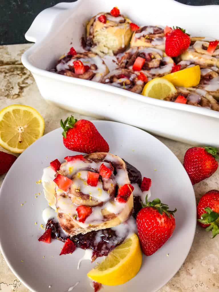 Homemade Strawberry Lemon Cinnamon Rolls with lemon icing glaze. Fresh strawberries and strawberry jam with cinnamon in a homemade dough. Bright spring and summer flavors for home breakfast and brunch baking recipes. #cinnamonrolls #strawberrylemon #bakingrecipes