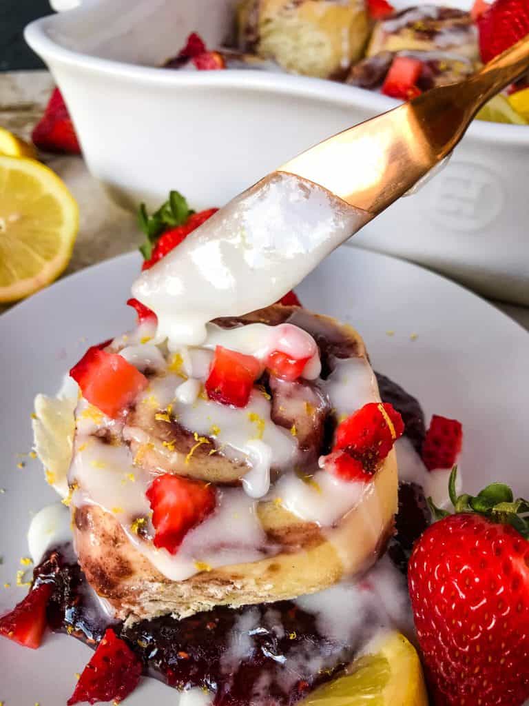 Homemade Strawberry Lemon Cinnamon Rolls with lemon icing glaze. Fresh strawberries and strawberry jam with cinnamon in a homemade dough. Bright spring and summer flavors for home breakfast and brunch baking recipes. #cinnamonrolls #strawberrylemon #bakingrecipes