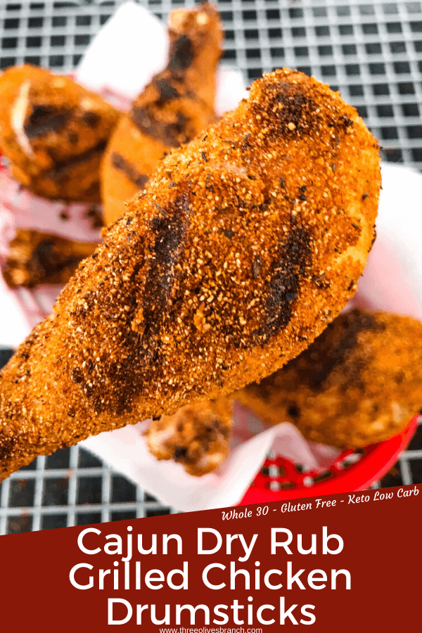 Pin image of Dry Rub Cajun Grilled Chicken Drumsticks with a close up of a grilled chicken drumstick with grill lines