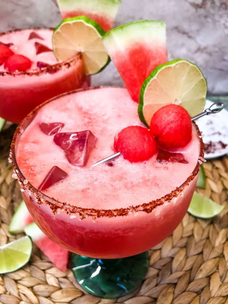 Top view of a Chile Lime Spicy Watermelon Margarita with a chile salt rim and watermelon and lime garnish