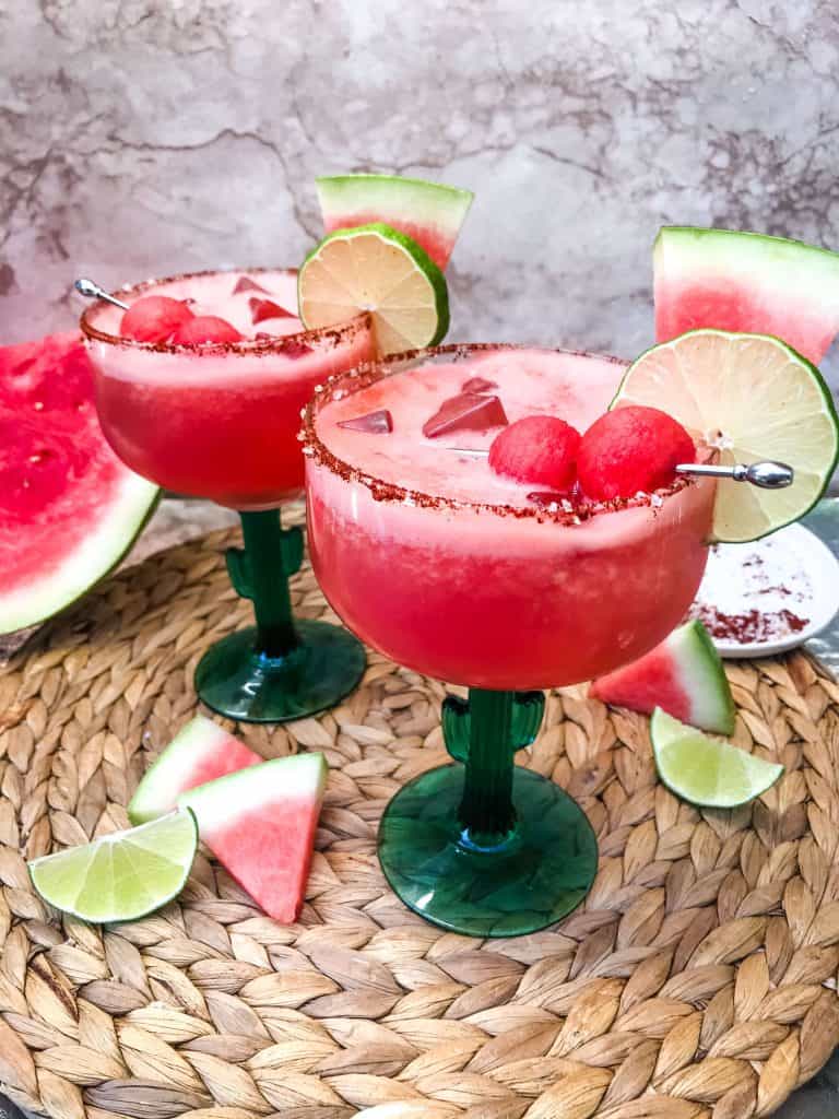 Two dark pink margaritas with a red chile salt rim