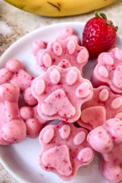 Close up of Frozen Strawberry Banana Dog Treats on a plate in a pile