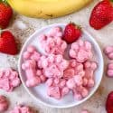 Frozen Strawberry Banana Dog Treats on a plate with fresh fruit around it