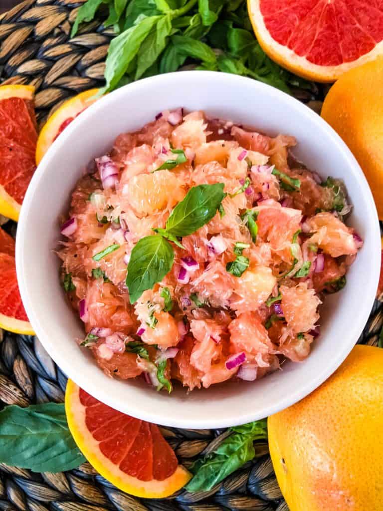 A white bowl filled with Grapefruit Basil Relish
