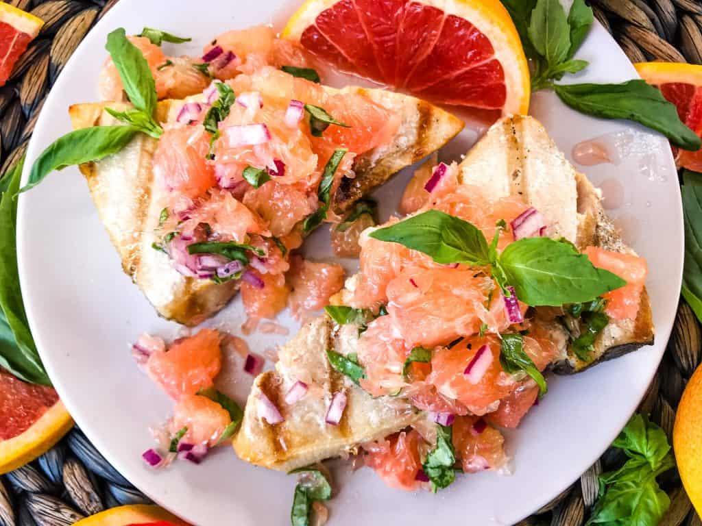 Close up overhead shot of two swordfish steaks with grapefruit relish