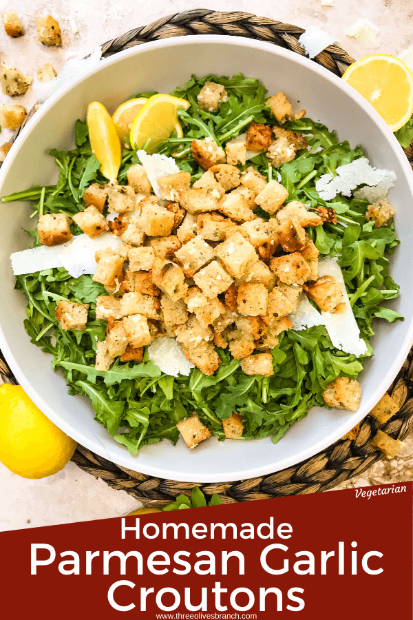 Pim image of Homemade Parmesan Garlic Croutons on lettuce in bowl with title at bottom