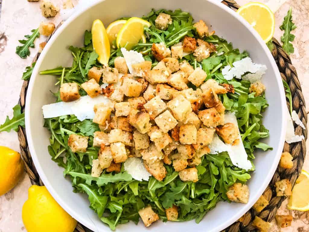 Horizontal image of Homemade Parmesan Garlic Croutons on lettuce