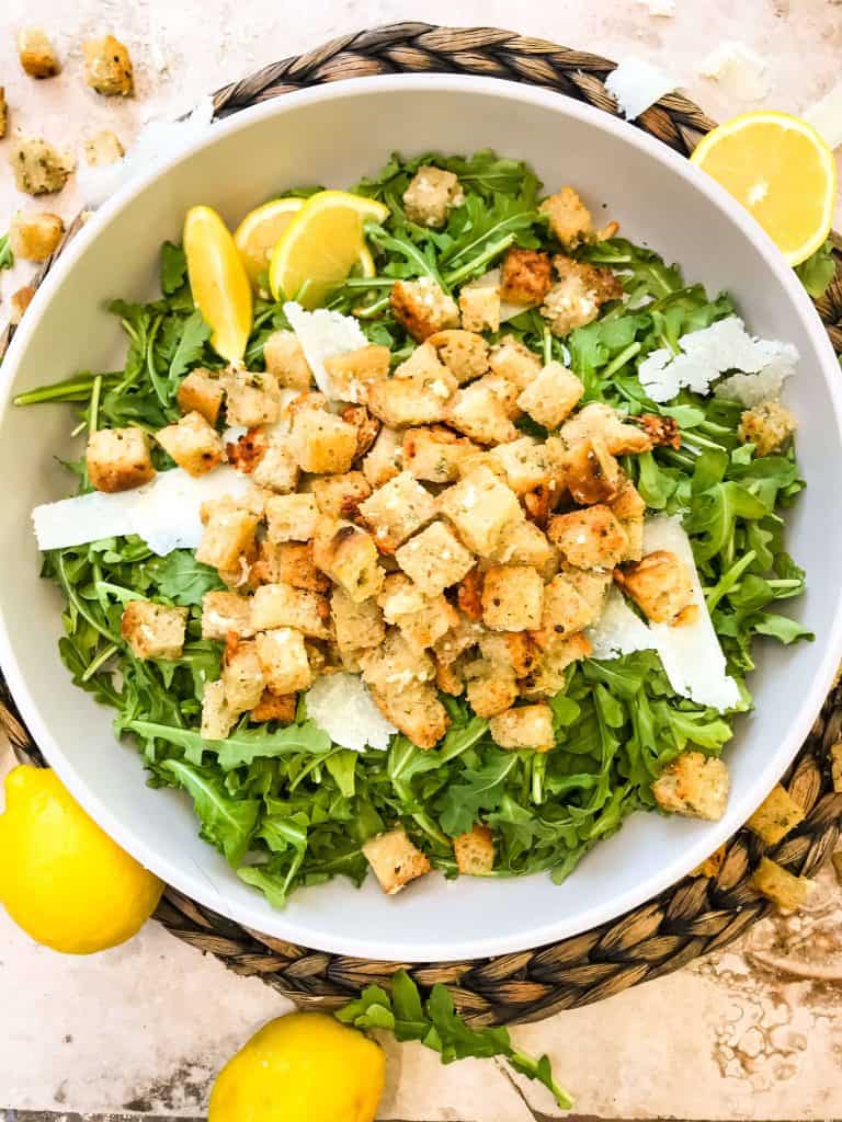 Lettuce topped with Homemade Parmesan Garlic Croutons in a shallow bowl