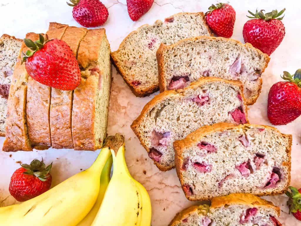 Many slices of banana bread with strawberries