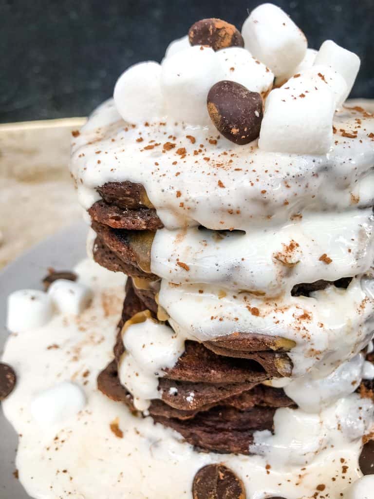 Close up of chocolate pancakes with a marshmallow sauce