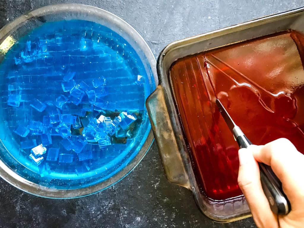 Cutting red and blue jello into cubes
