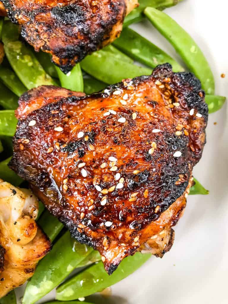 Sesame Soy Glazed Grilled Chicken Thighs are an easy grilled chicken recipe. BBQ bone in grilled chicken thighs are coated in a simple Asian glaze sauce. #grilledchickenthighs #glazedchickenrecipes #asianchickenrecipes