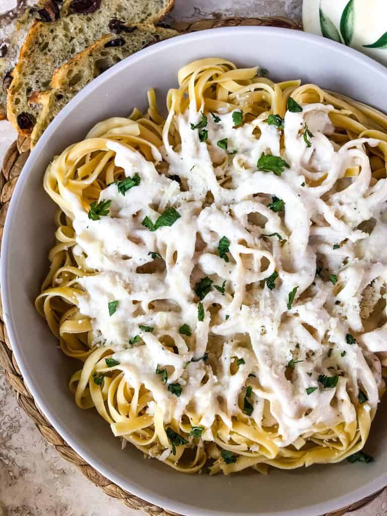Fettuccine noodles with white sauce on it
