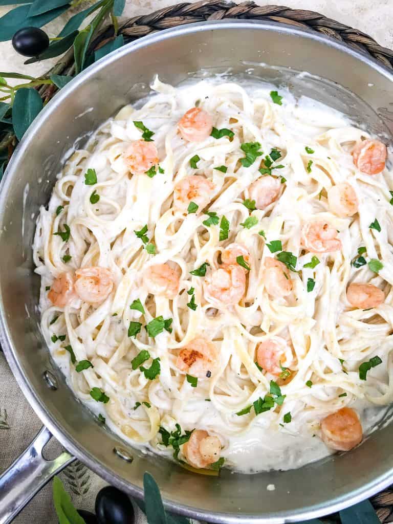 A large skillet full of Copycat Olive Garden Shrimp Alfredo