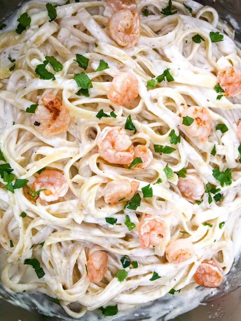 A close up of Copycat Olive Garden Shrimp Alfredo with small shrimp