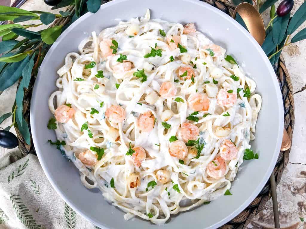 Shrimp and scallop Parmesan pasta in a bowl