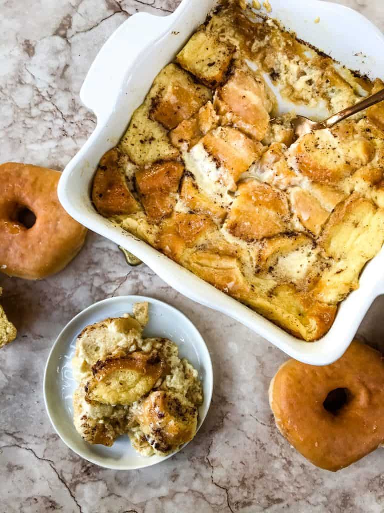 Dish of Doughnut Bread Pudding with a small plate of it next to it 