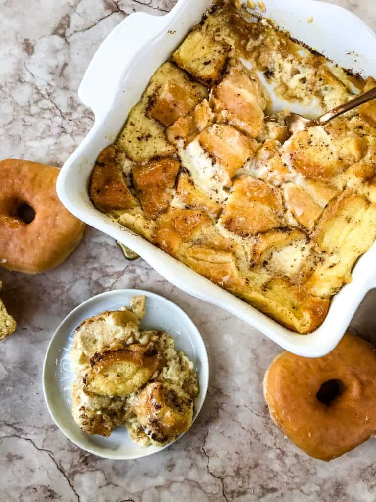Dish of Doughnut Bread Pudding with a small plate of it next to it 
