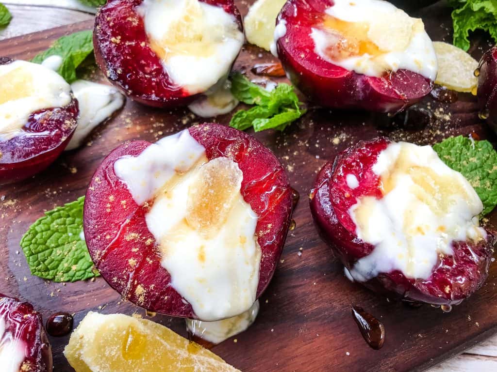 Horizontal close up of fruit with yogurt on top with mint