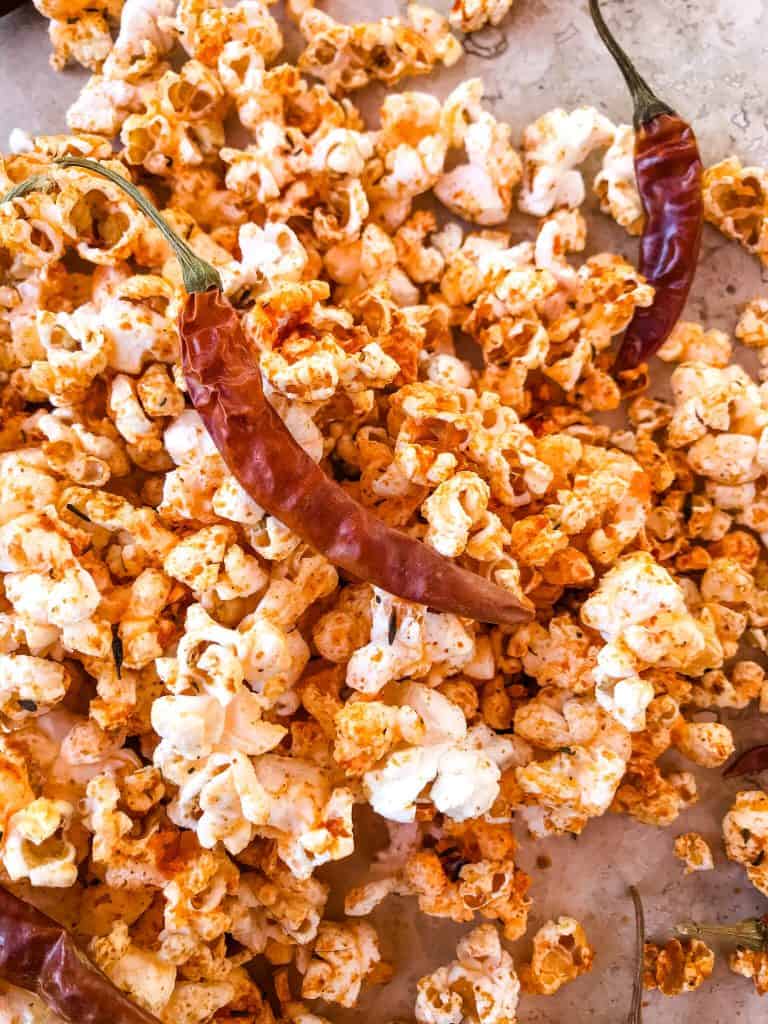 A pile of popcorn with a pepper