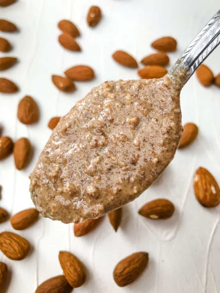 A spoon of chunky nut butter