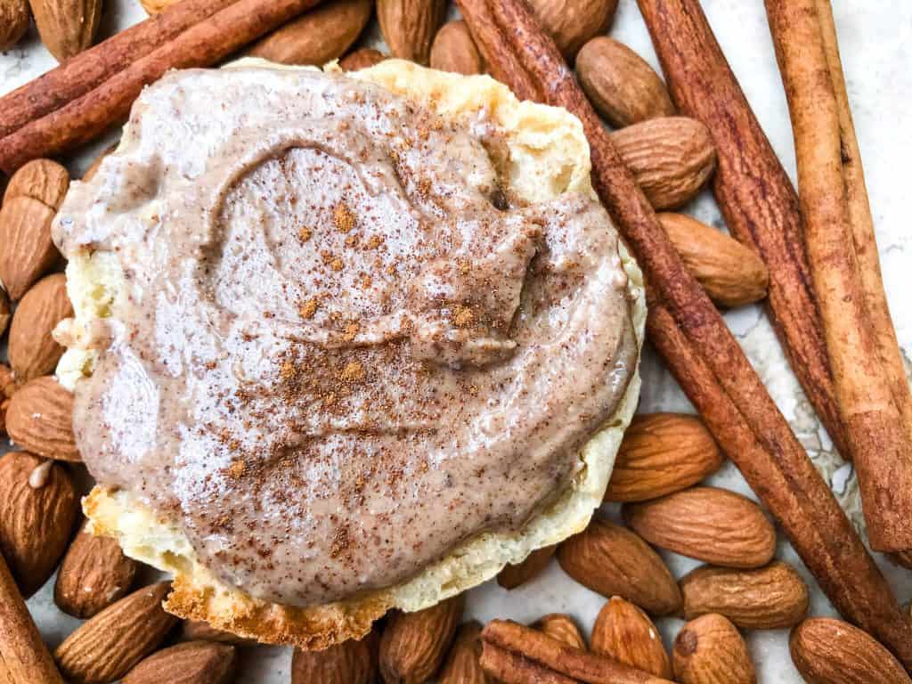 A horizontal image of Homemade Cinnamon Almond Butter on an English muffin