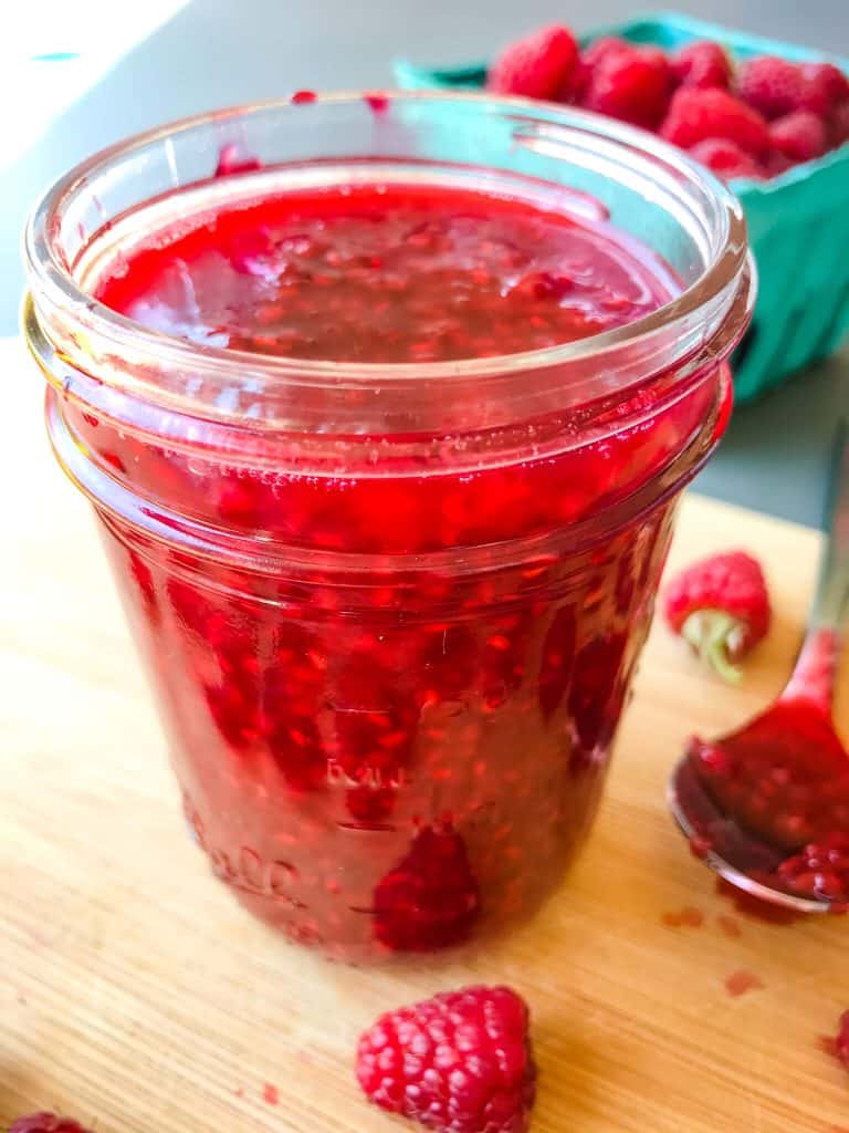 A full clear jar of Raspberry Jam Recipe