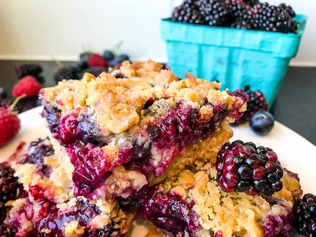 Bars on a plate with berries around it