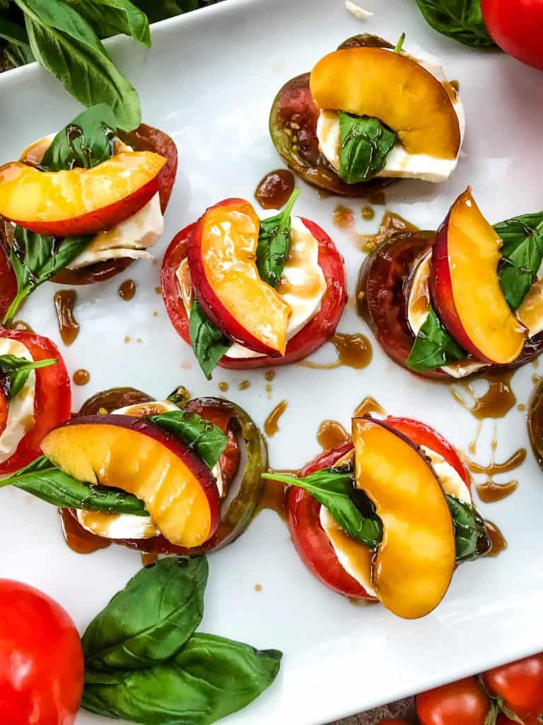 Stacks of Nectarine Tomato Caprese Salad (Peach Caprese Salad) drizzled with balsamic glaze