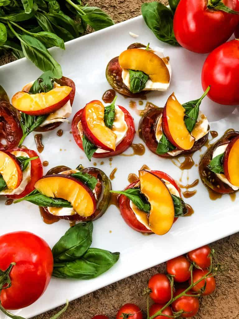 A plate of Nectarine Tomato Caprese Salad (Peach Caprese Salad) stacks