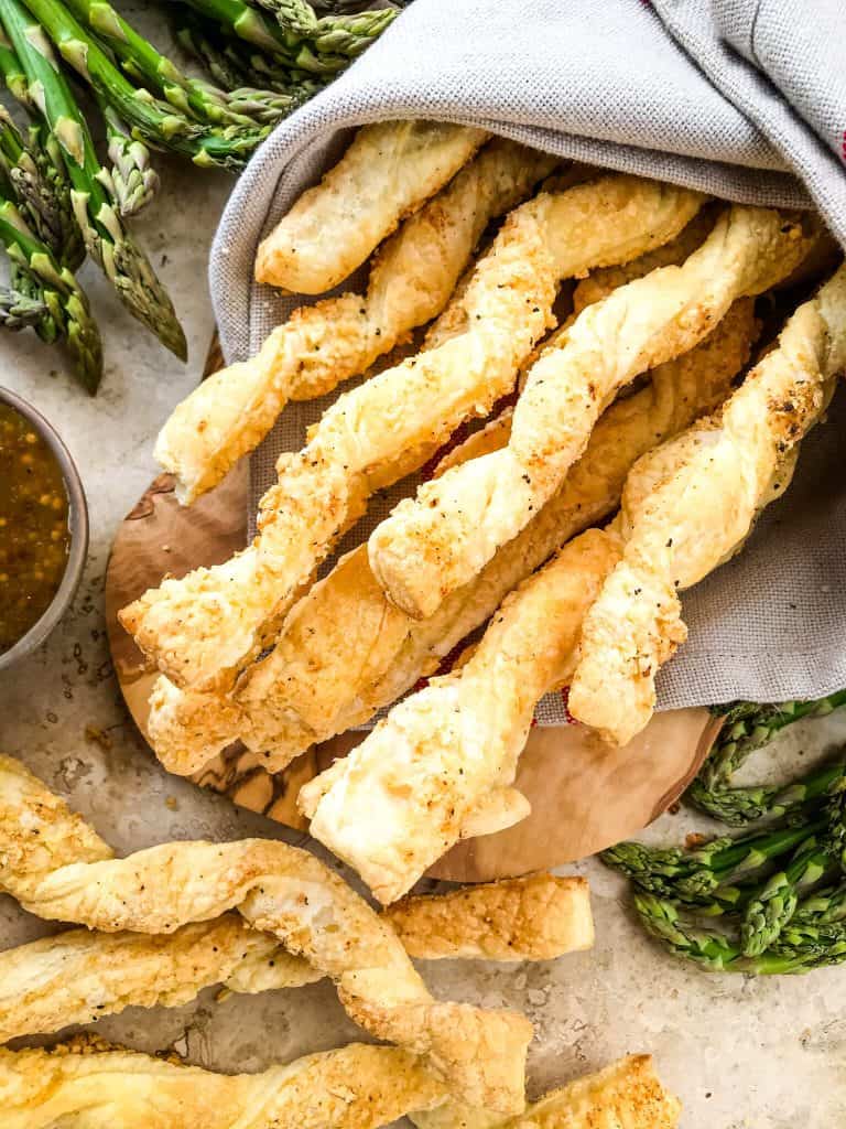Garlic Parmesan Cheese Straws wrapped up in a towel