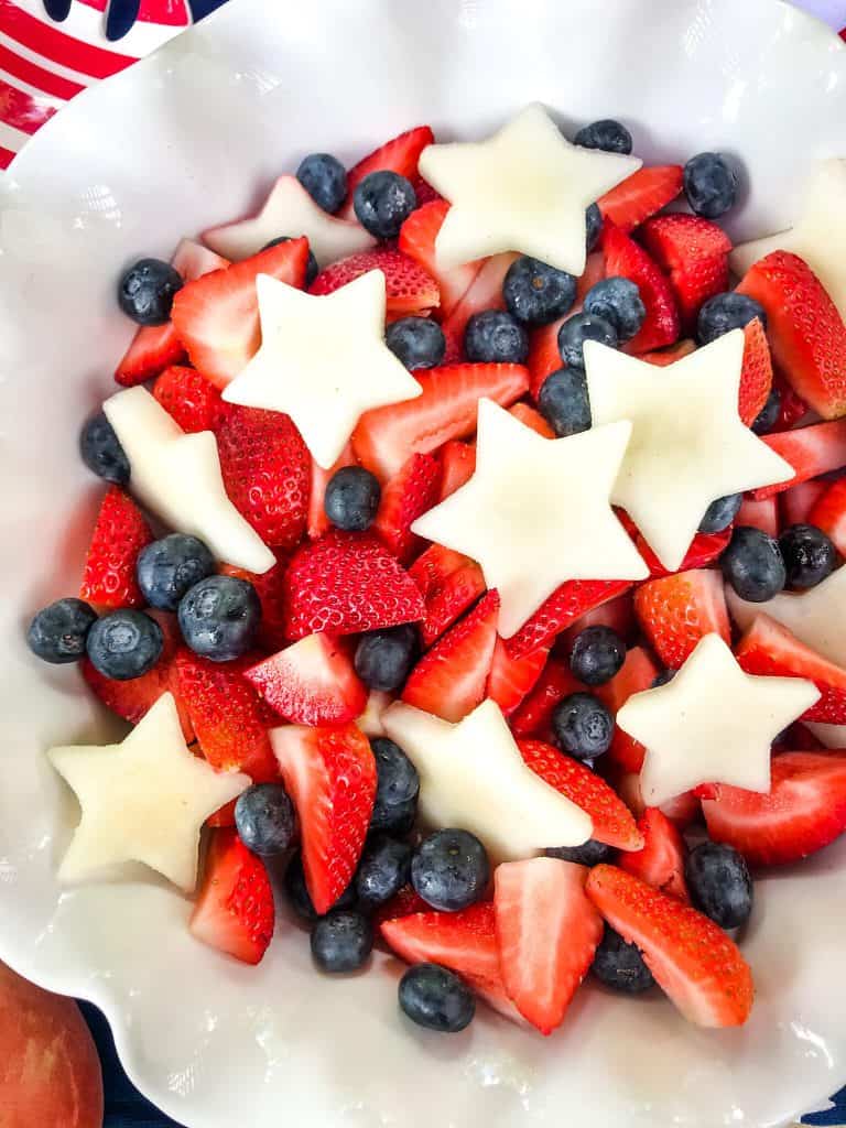 A white bowl with Patriotic Red, White, and Blue Fruit Salad