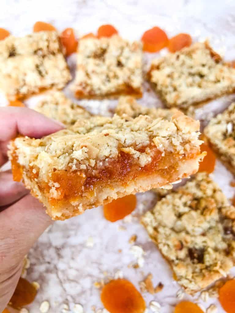 A hand holding a Apricot Crumble Bar
