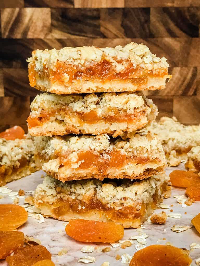 Apricot Crumble Bars in a stack surrounded by dried fruit