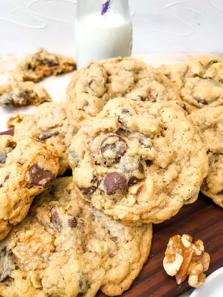 A pile of Real DoubleTree Cookies Recipe with milk behind it