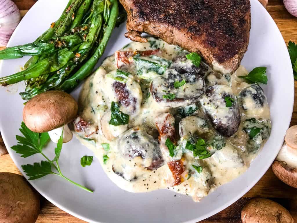 Tuscan Creamy Mushrooms with sun-dried tomatoes, spinach, and garlic in a Parmesan cream sauce