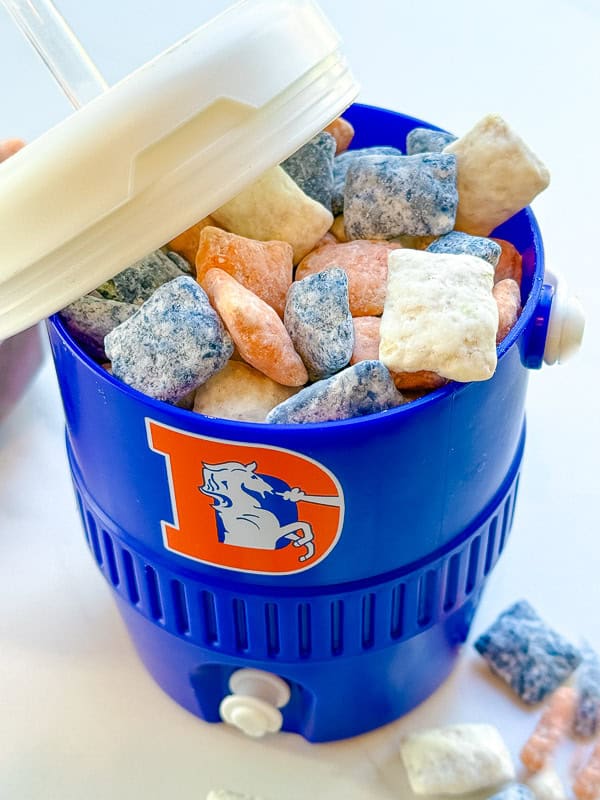 Looking inside a blue cooler cup at the Denver Broncos Puppy Chow.