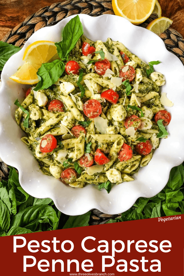 Pin of Pesto Caprese Penne Pasta from the top with lemons in a white dish and title at bottom